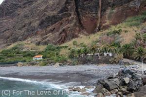 The Fajã dos Padres seen from the sea. Note funicular lift up the side of the cliff and restaurant on the right