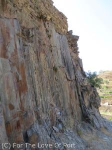 One of the unusually high stone retaining walls incorporating the natural schist outcrop